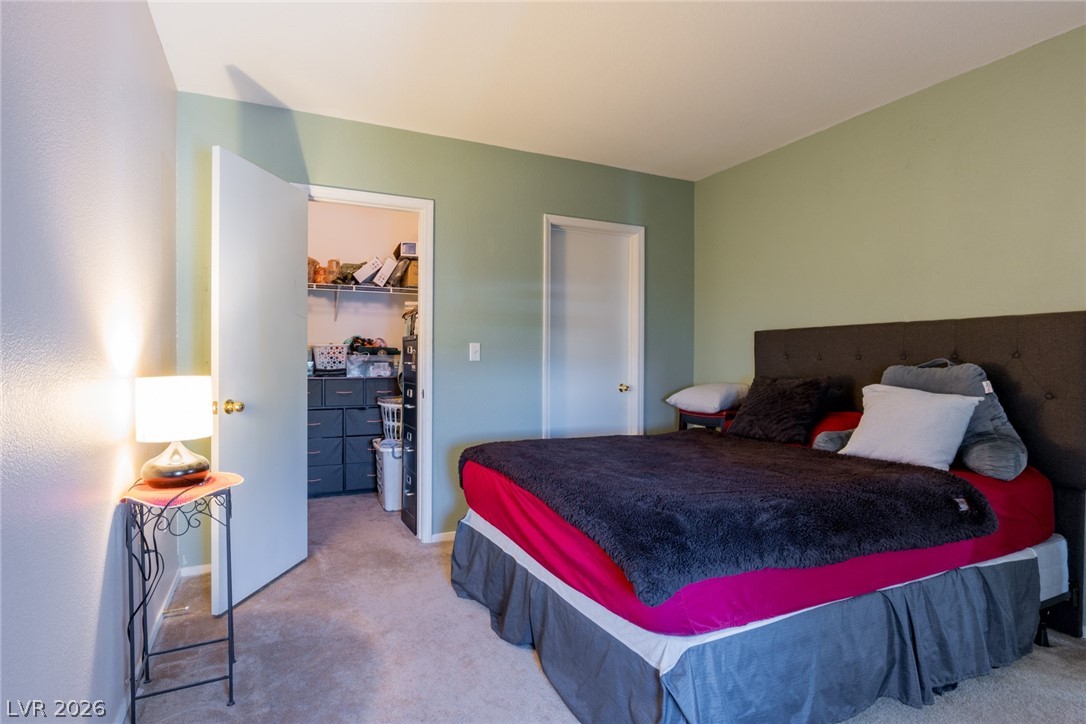 7255 West Sunset Road, Unit 2030 Las Vegas, NV 89113 - Photo 16 of 24 Bedroom with a spacious closet and light carpet