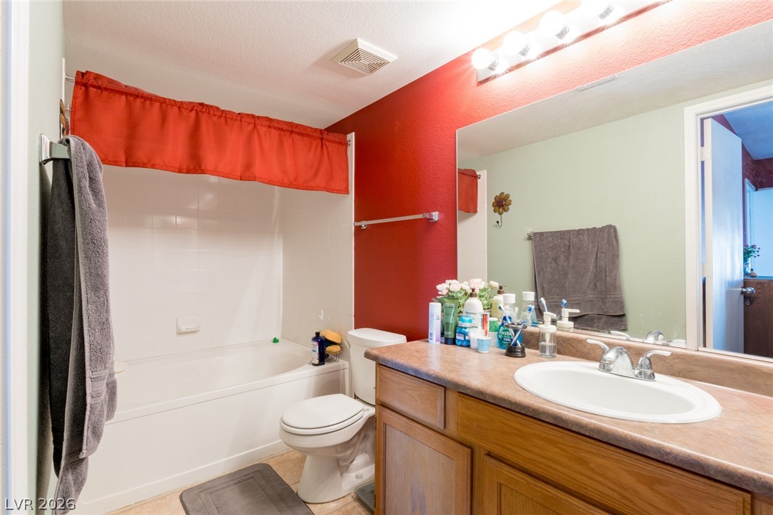 7255 West Sunset Road, Unit 2030 Las Vegas, NV 89113 - Photo 19 of 24 Bathroom featuring vanity, shower / tub combo with curtain, and light tile patterned flooring
