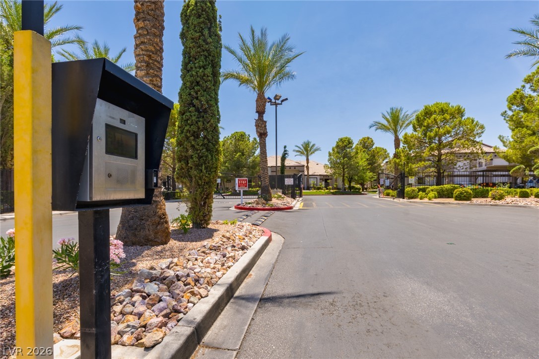7255 West Sunset Road, Unit 2030 Las Vegas, NV 89113 - Photo 24 of 24 View of asphalt street featuring a gated entry, street lights, curbs, and a residential view