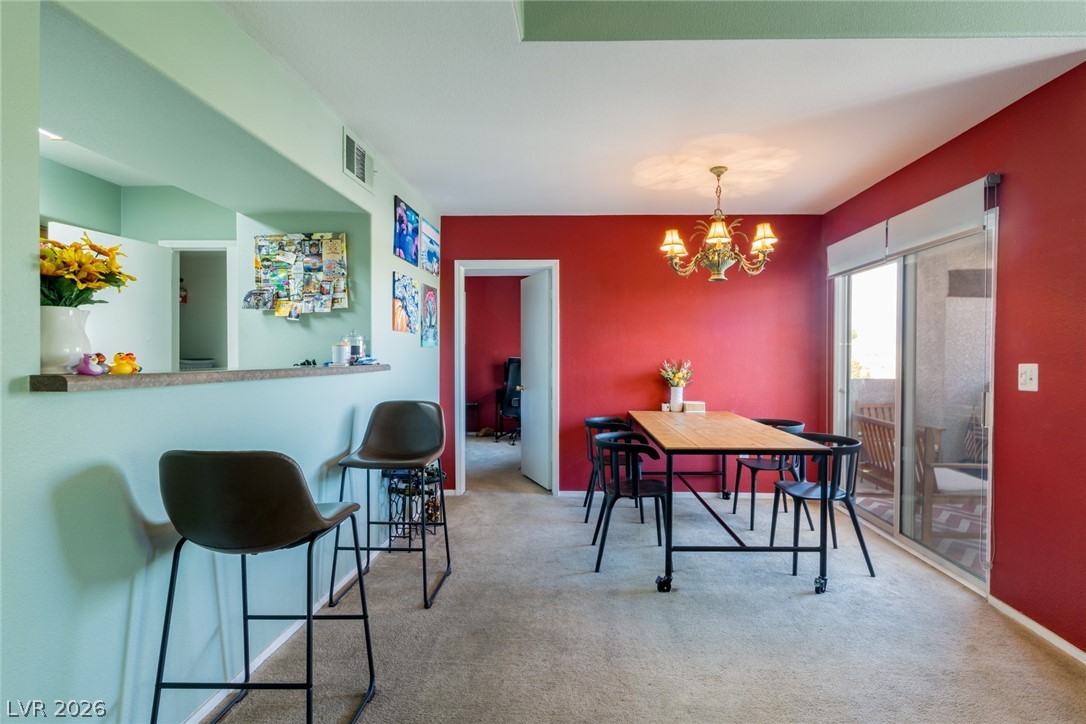 7255 West Sunset Road, Unit 2030 Las Vegas, NV 89113 - Photo 3 of 24 Dining room featuring hanging lights and light carpet