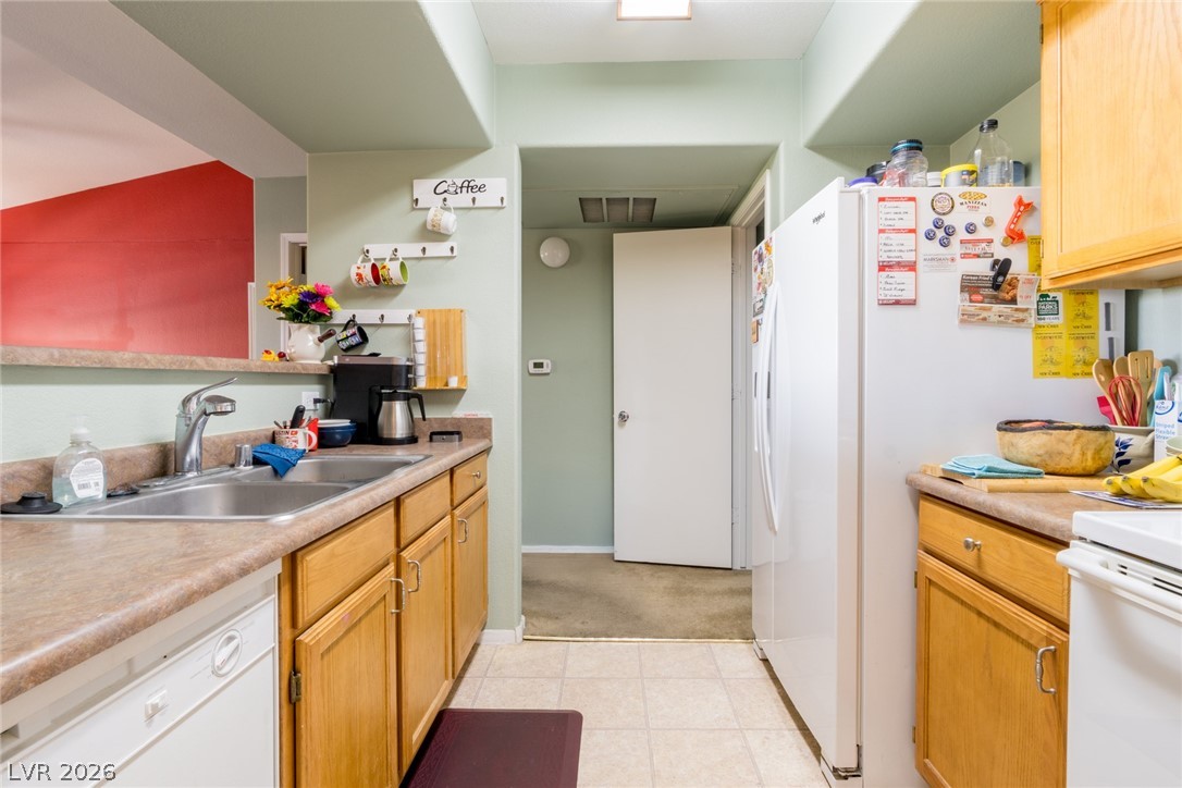 7255 West Sunset Road, Unit 2030 Las Vegas, NV 89113 - Photo 6 of 24 Kitchen featuring white appliances and light countertops