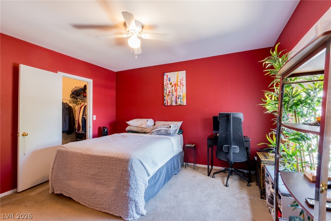 7255 West Sunset Road, Unit 2030 Las Vegas, NV 89113 - Photo 10 of 24 Bedroom featuring ceiling fan, carpet flooring, an office area, and a spacious closet