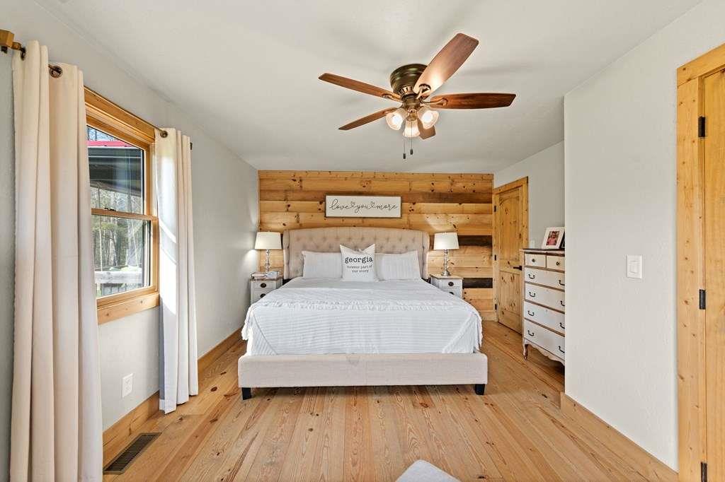 384 Maxwell Road Blue Ridge, GA 30513 - Photo 24 of 68 a bedroom with a bed and wooden floor