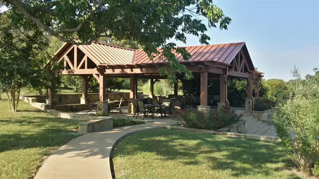 a view of a house with backyard porch and sitting area