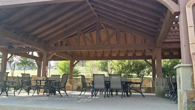 a view of a house with backyard sitting area and swimming pool