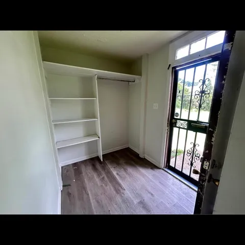 a open area with wooden floor and windows