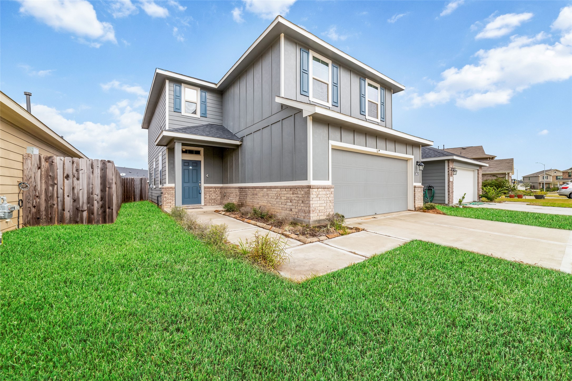 21622 Buttonsage Lane Katy, TX 77449 - Photo 2 of 17 a front view of a house with a yard and garage