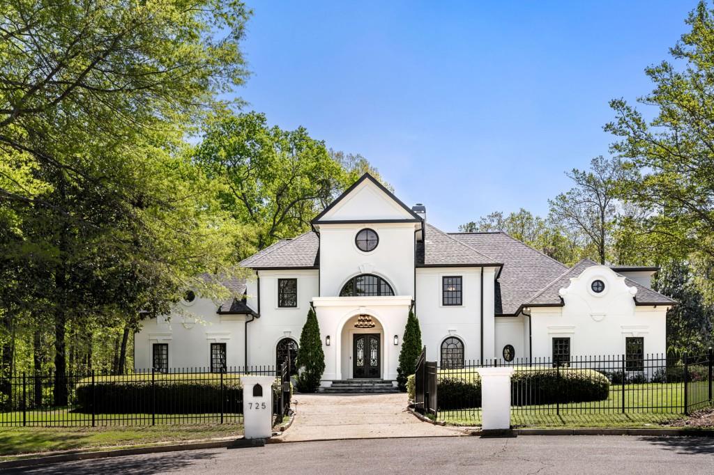 725 Riley Place Northwest Atlanta, GA 30327 - Photo 1 of 1 a front view of a white house with a white fence
