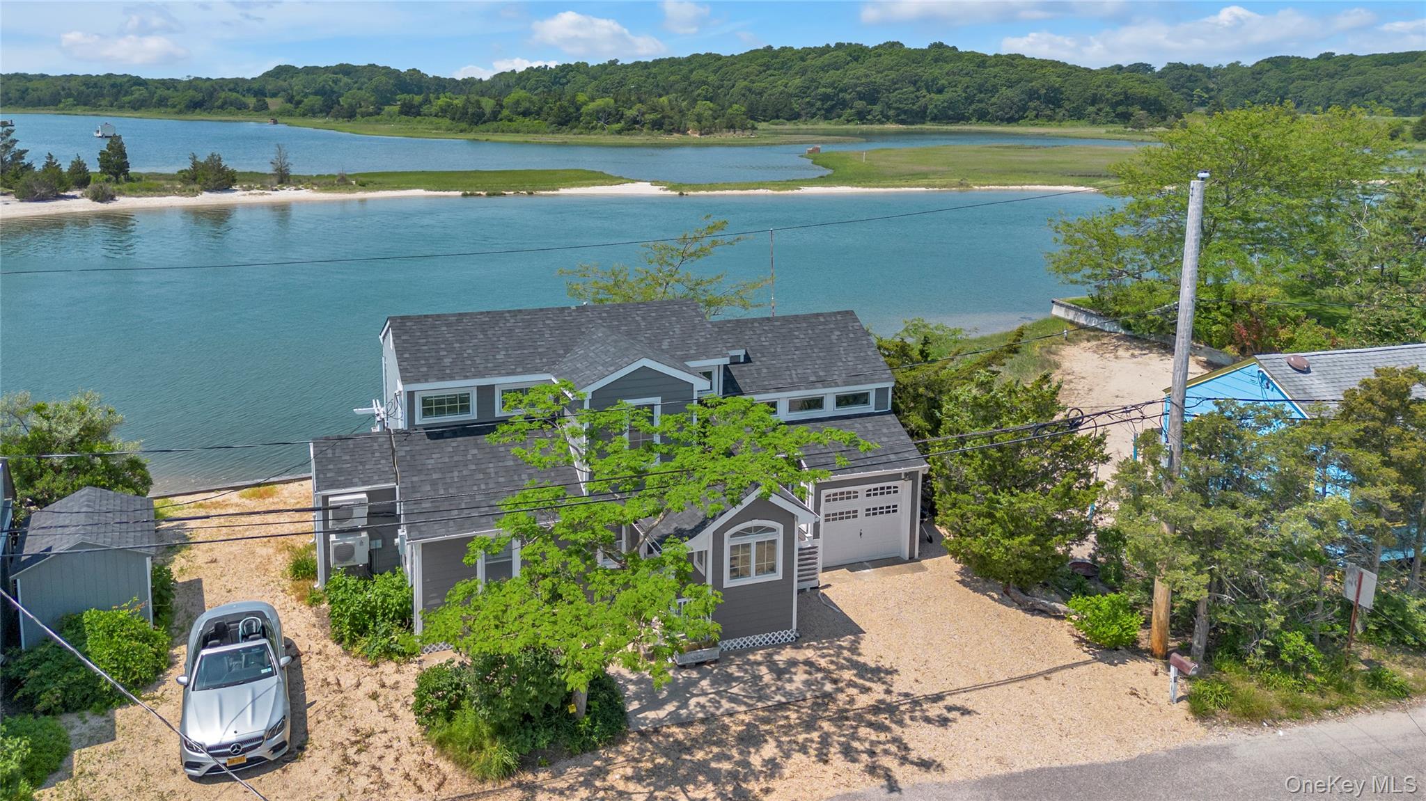 an aerial view of a house with garden space and lake view