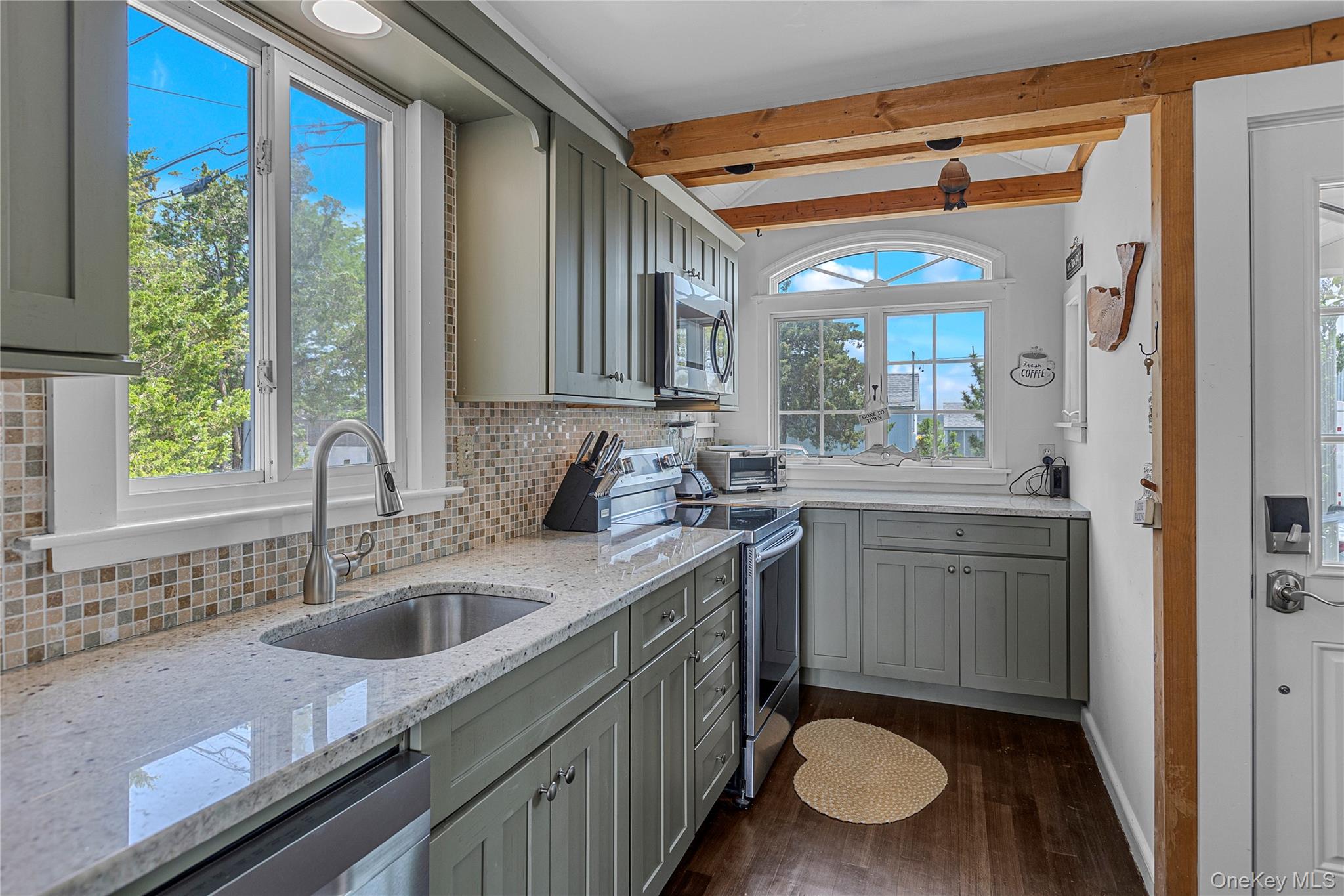 286 Towd Point Road Southampton, NY 11968 - Photo 13 of 35 a bathroom with a granite countertop sink a toilet a mirror and window