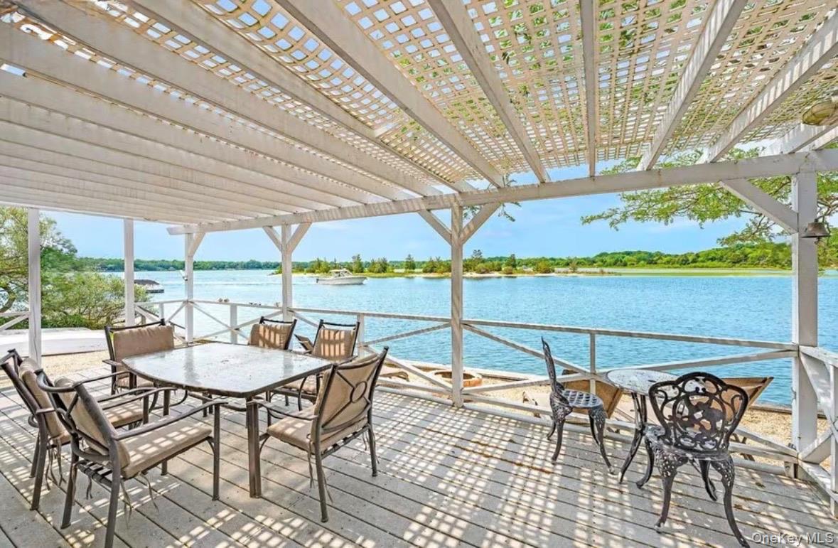 286 Towd Point Road Southampton, NY 11968 - Photo 2 of 35 a view of a dining room with furniture one side kitchen view and wooden floor