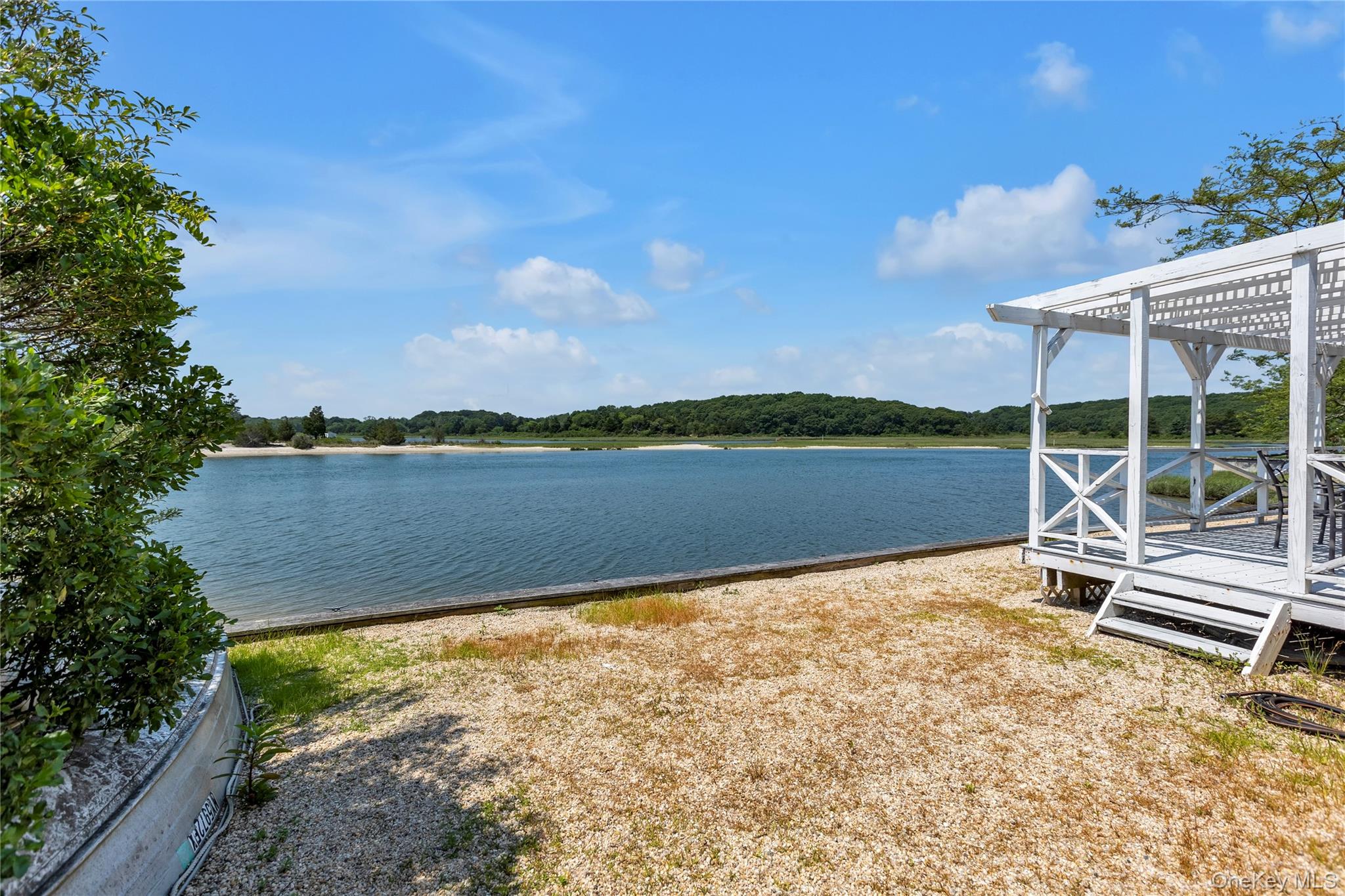 286 Towd Point Road Southampton, NY 11968 - Photo 33 of 35 a view of a lake with a garden and trees
