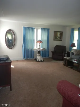 a living room with furniture and a mirror