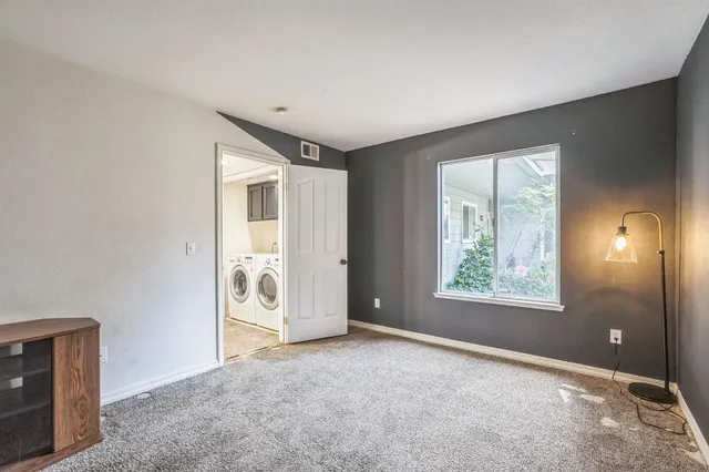 an empty room with windows and closet