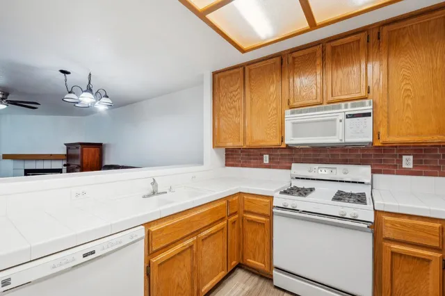 a kitchen with stainless steel appliances a sink stove and cabinets