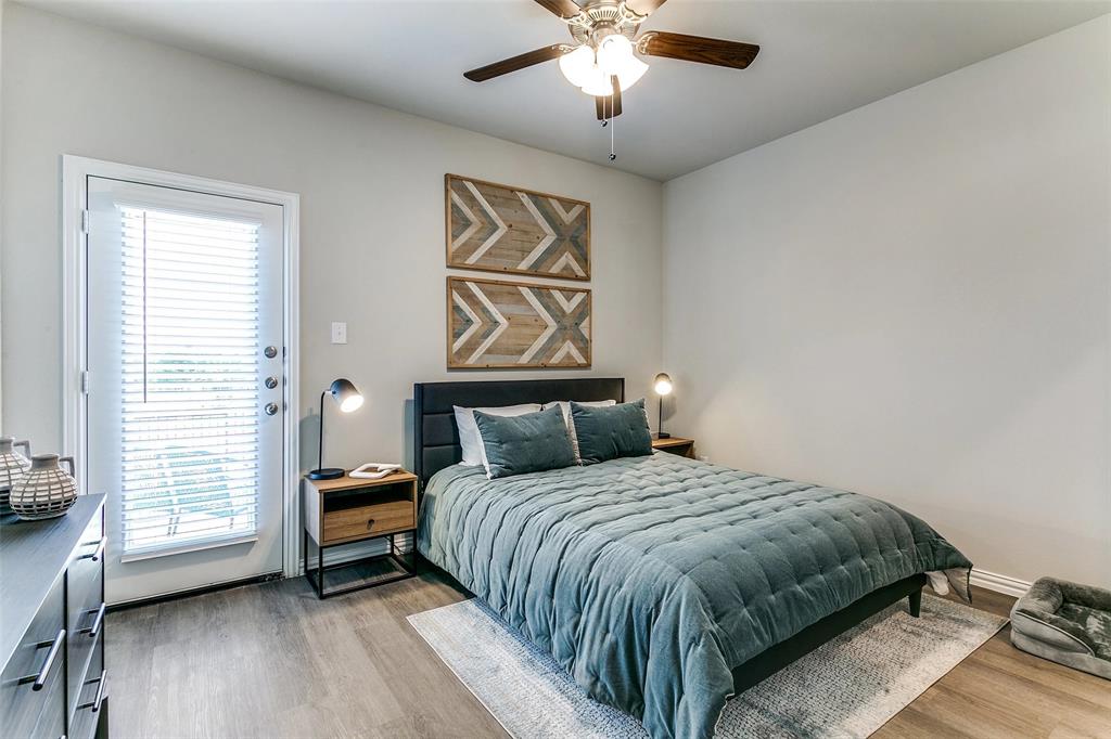 5401 Barlean Ranch, Unit 29U Fort Worth, TX 76123 - Photo 4 of 18 a bedroom with a large bed and a chandelier