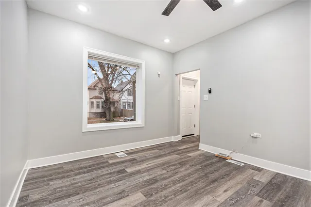 an empty room with windows and closet