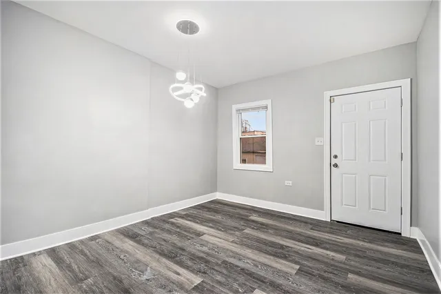 a view of a livingroom with wooden floor and ceiling fan