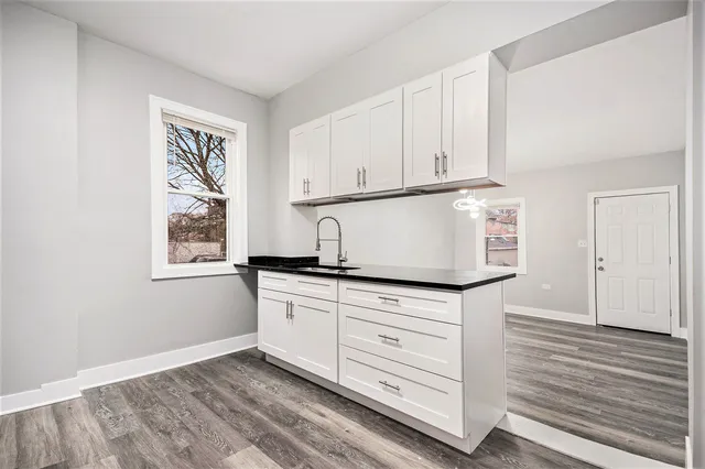 a view of room with window and wooden floor