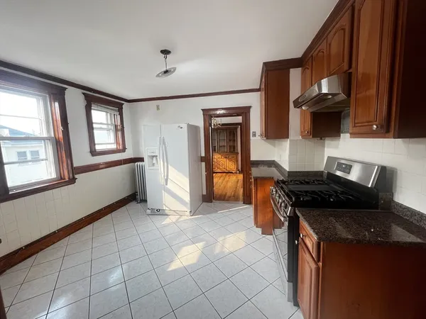 a kitchen with a stove a sink and a microwave