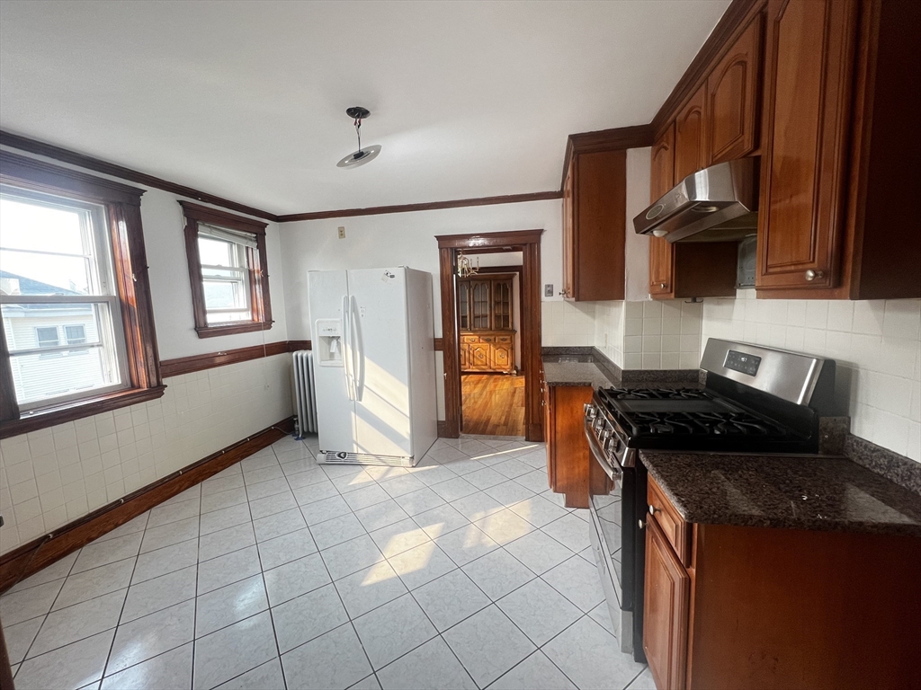 a kitchen with a stove a sink and a microwave