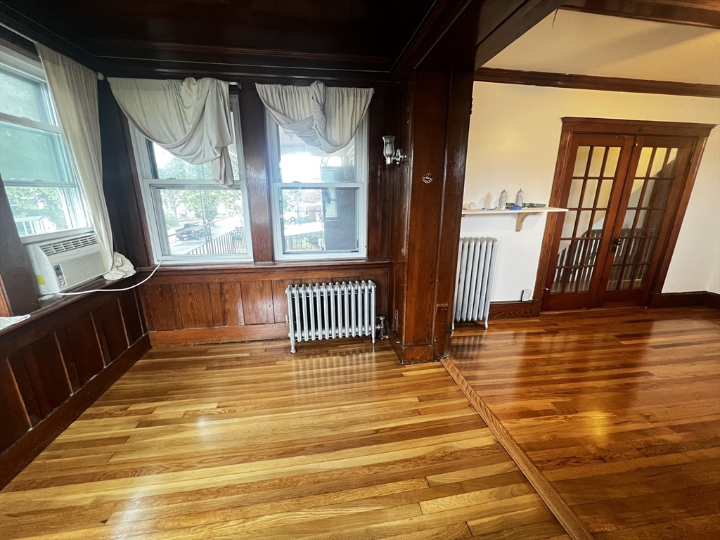 103 St Andrew Road, Unit 2 Boston, MA 02128 - Photo 13 of 20 a view of a room with wooden floor and windows