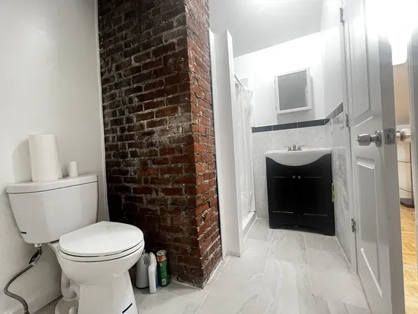 a bathroom with a toilet a sink and a shower