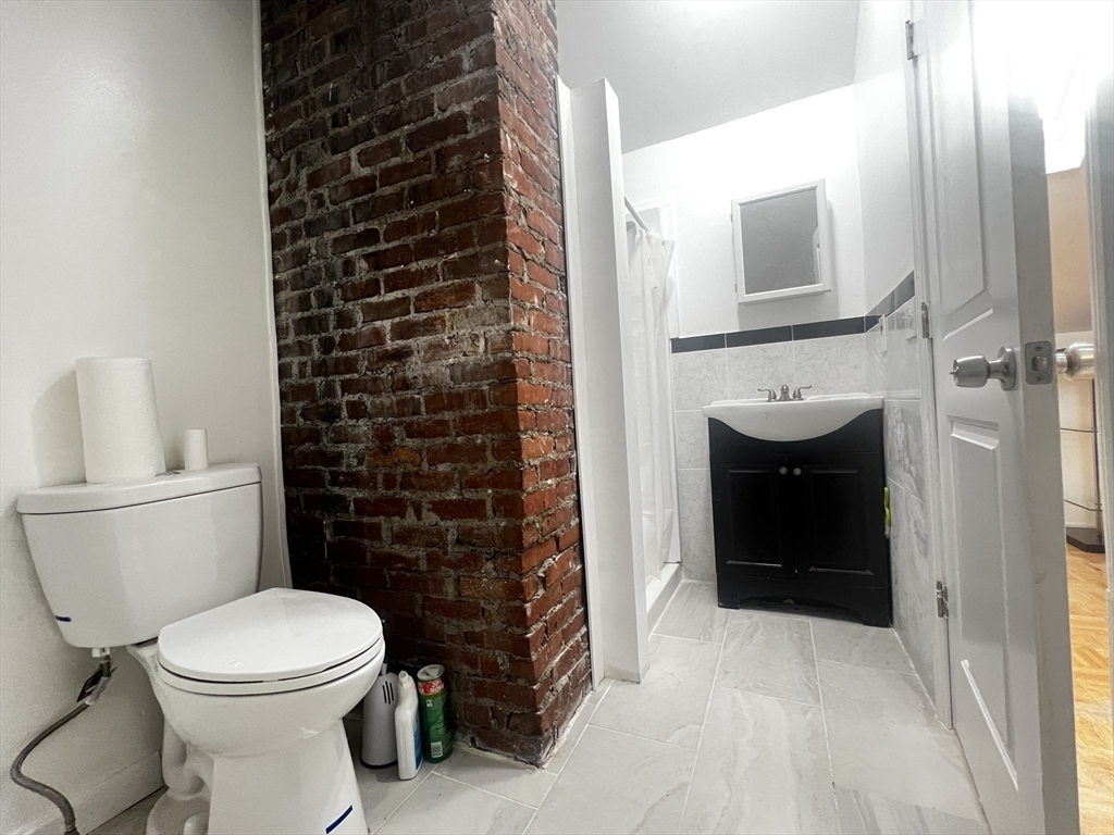 103 St Andrew Road, Unit 2 Boston, MA 02128 - Photo 15 of 20 a bathroom with a toilet a sink and a shower