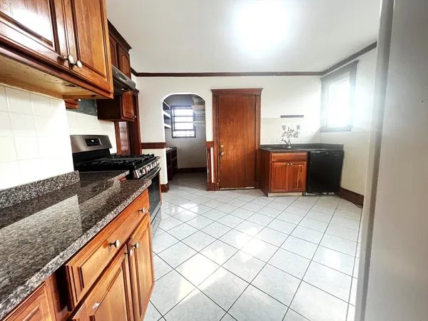 a kitchen with stainless steel appliances granite countertop a sink and cabinets