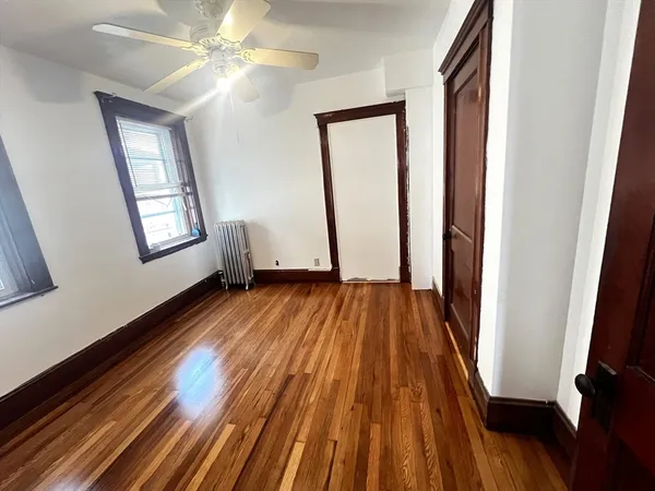 wooden floor in an empty room with a window