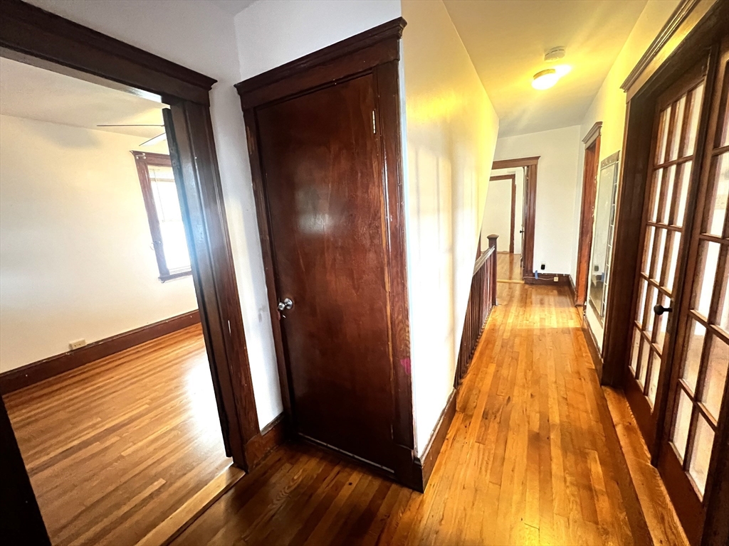 103 St Andrew Road, Unit 2 Boston, MA 02128 - Photo 10 of 20 a view of a hallway with wooden floor and staircase