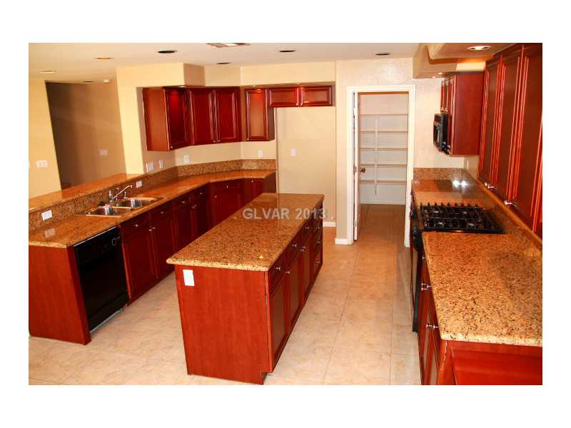 656 Doubleshot Lane Henderson, NV 89052 - Photo 3 of 35 Kitchen. island, granite, walk in pantry, tons cabinet space. What more do you ask for?