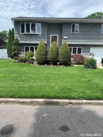 a front view of brick house with a yard
