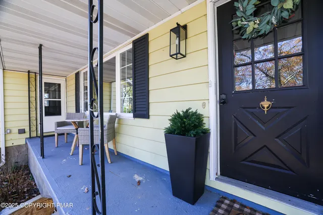 a living room with lots of furniture wooden floor and a chandelier