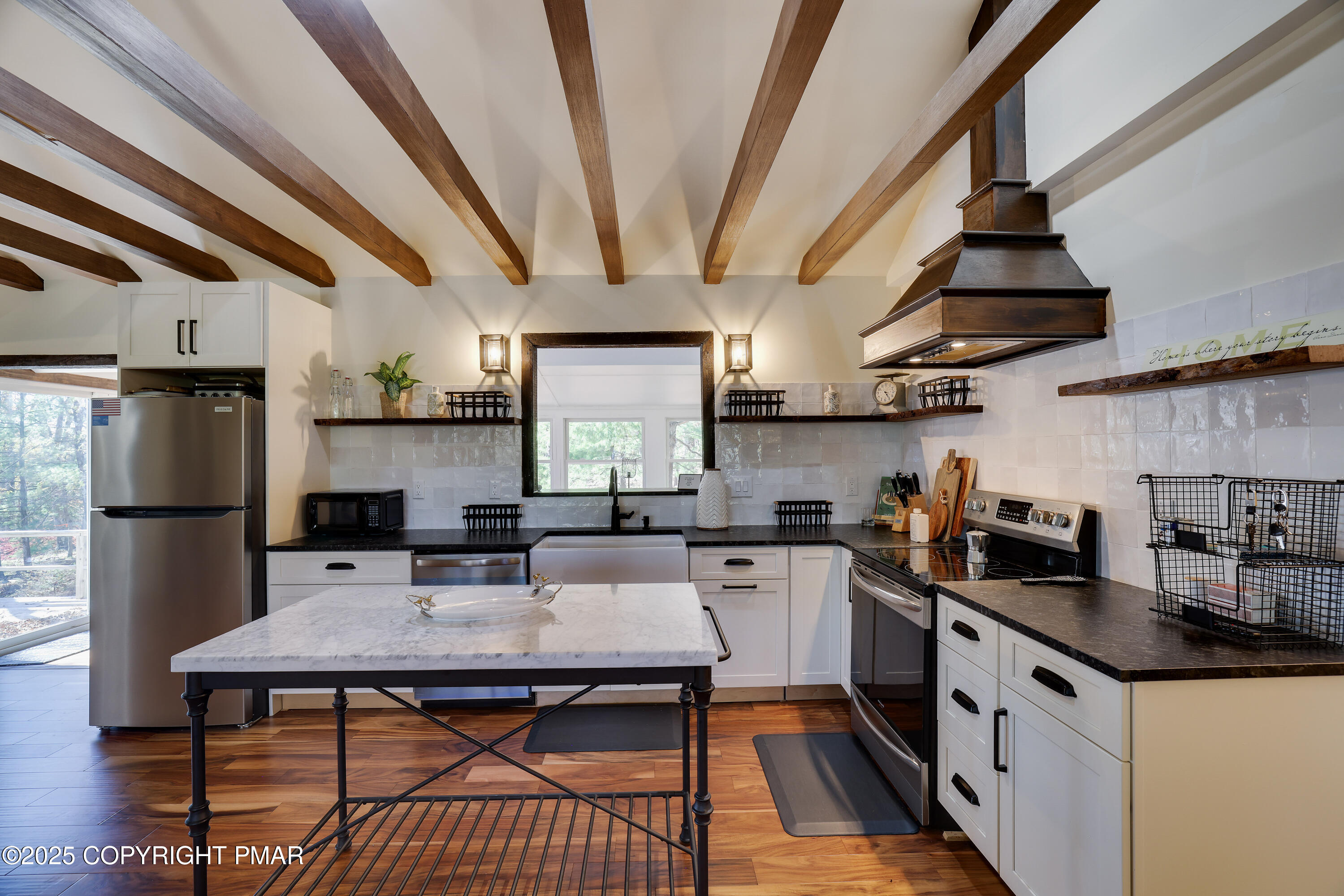 104 Haverhill Road Cresco, PA 18326 - Photo 11 of 86 a kitchen with stainless steel appliances a stove a sink dishwasher a refrigerator white cabinets a dining table and chairs with wooden floor