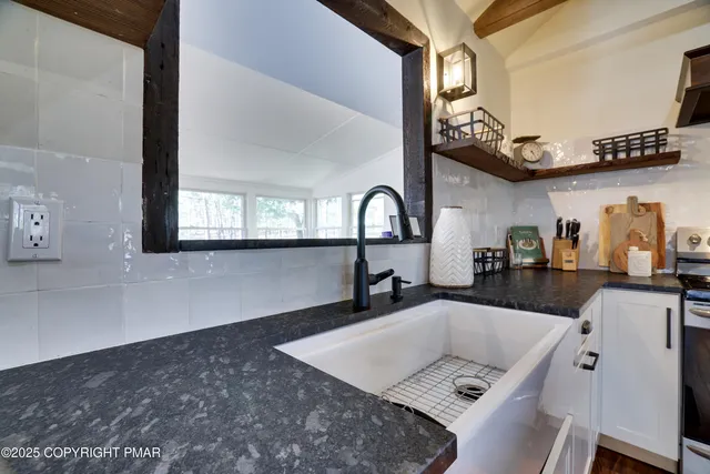 a bathroom with a sink vanity mirror and toilet