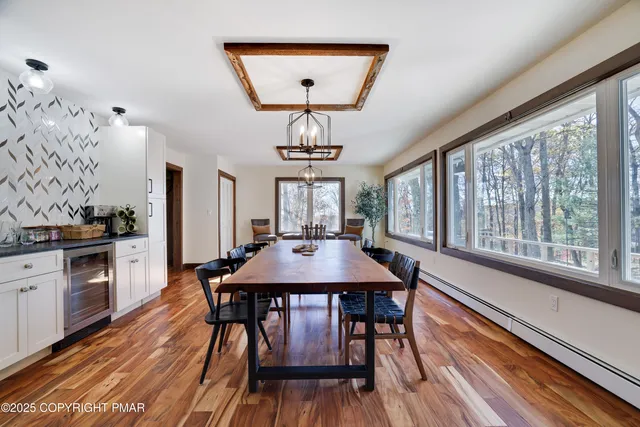 a view of a yard with plants and large trees