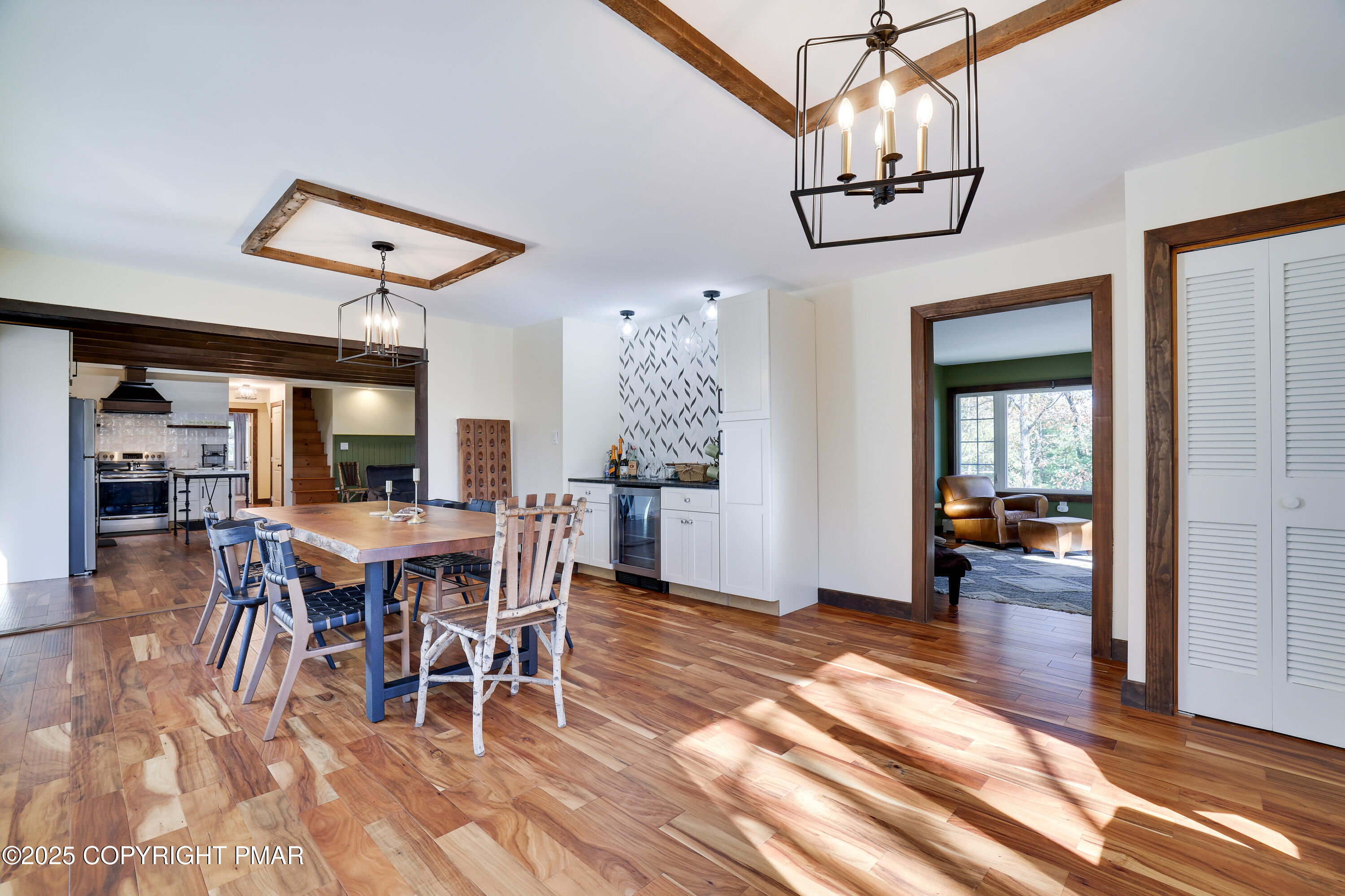 104 Haverhill Road Cresco, PA 18326 - Photo 18 of 86 a dining room with wooden floor a chandelier a wooden table and chairs