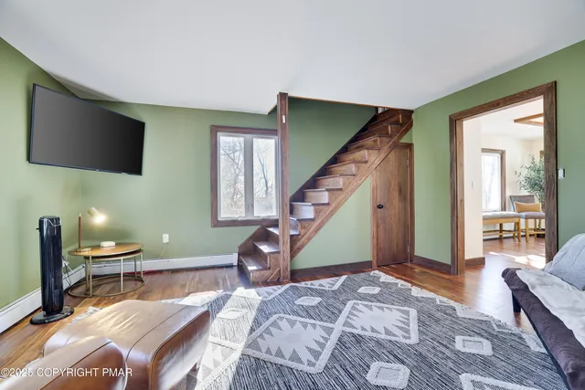 an aerial view of a house with a garden and lake view