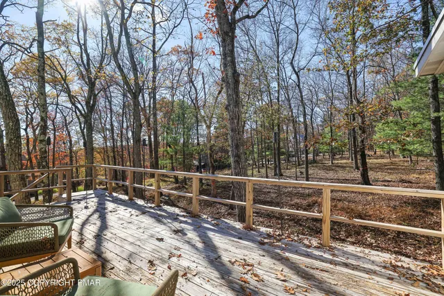 an aerial view of green landscape with trees houses and mountain view