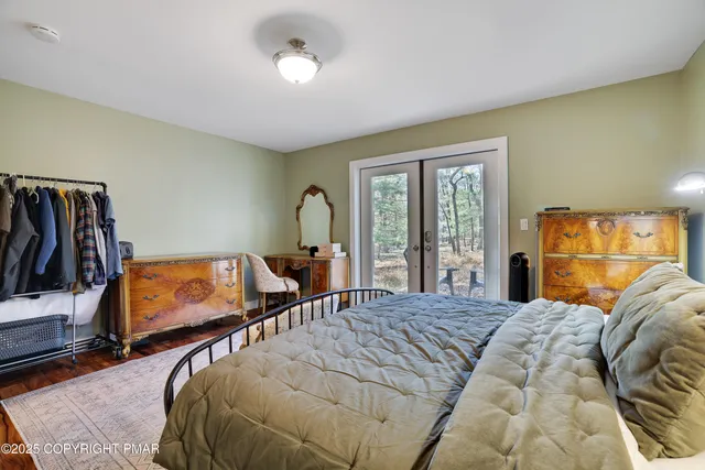 an aerial view of residential houses with outdoor space and trees