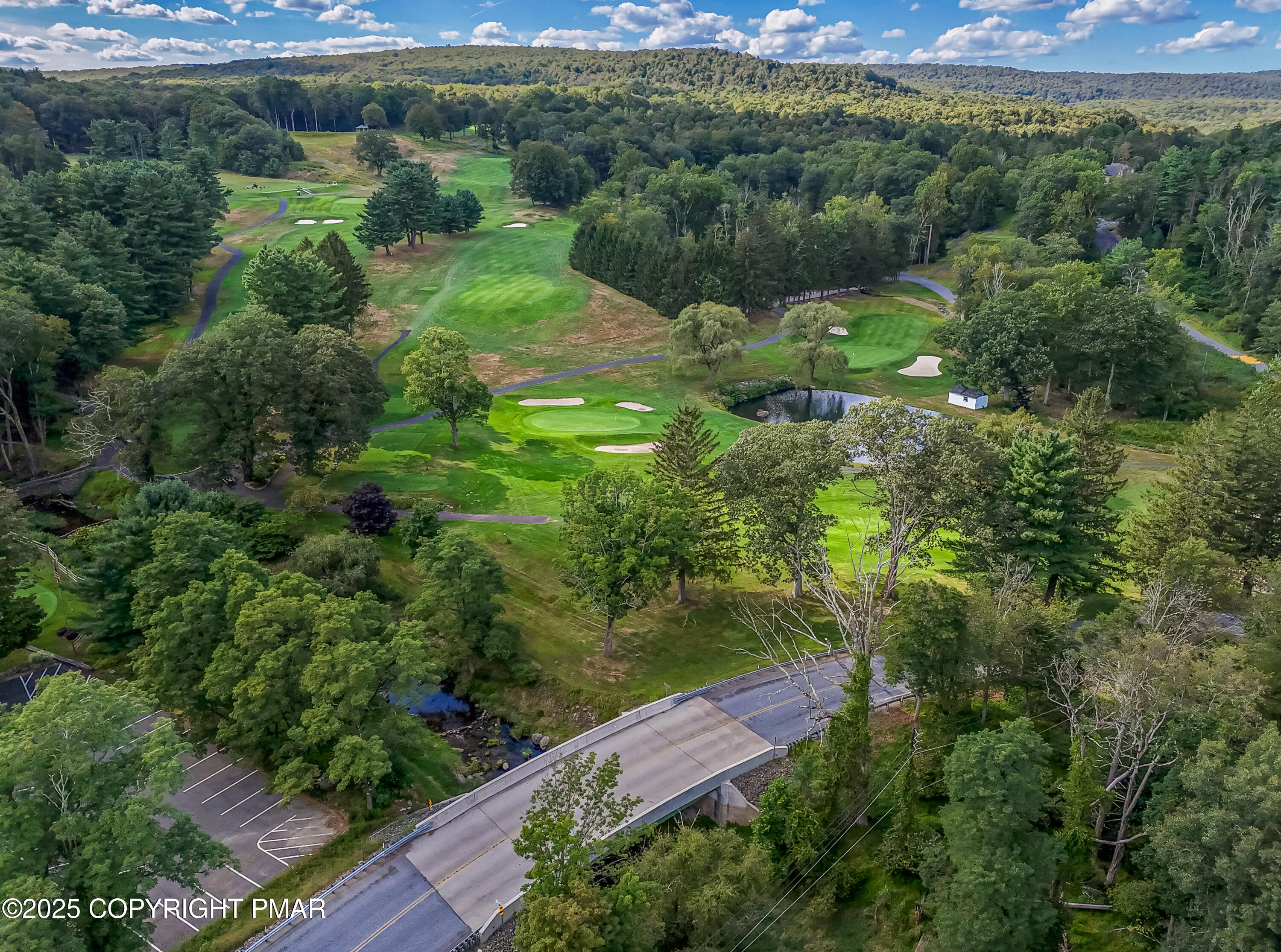 104 Haverhill Road Cresco, PA 18326 - Photo 79 of 86 an aerial view of green landscape with trees houses and mountain view