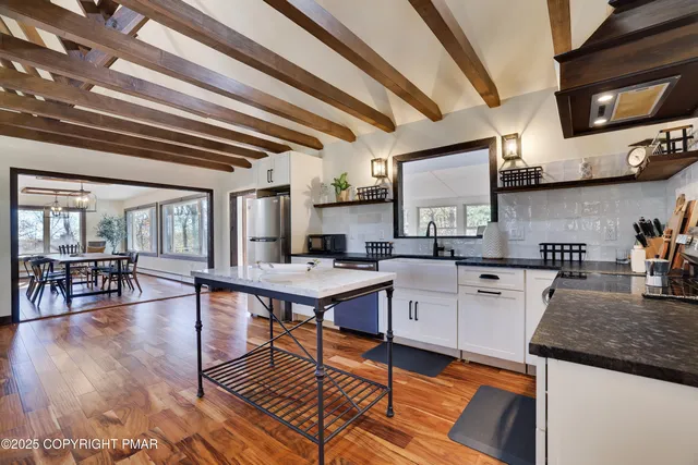 a view of a yard with wooden fence and trees
