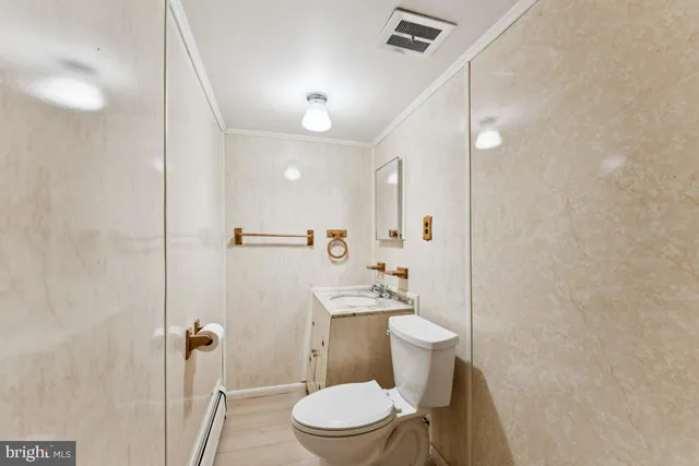 a bathroom with a toilet a sink and shower