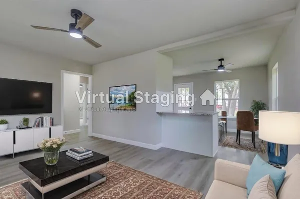 a living room with furniture and a flat screen tv