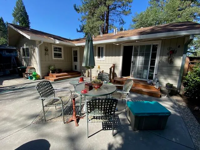 a view of a patio with table and chairs and potted plants