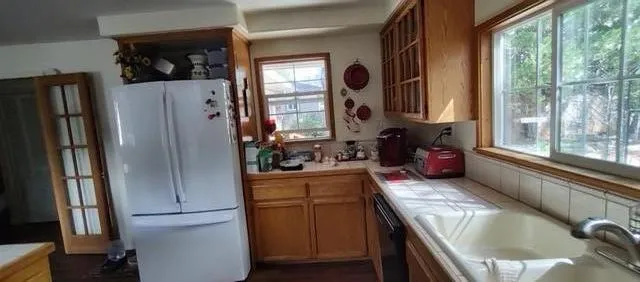 a kitchen with a refrigerator and a stove