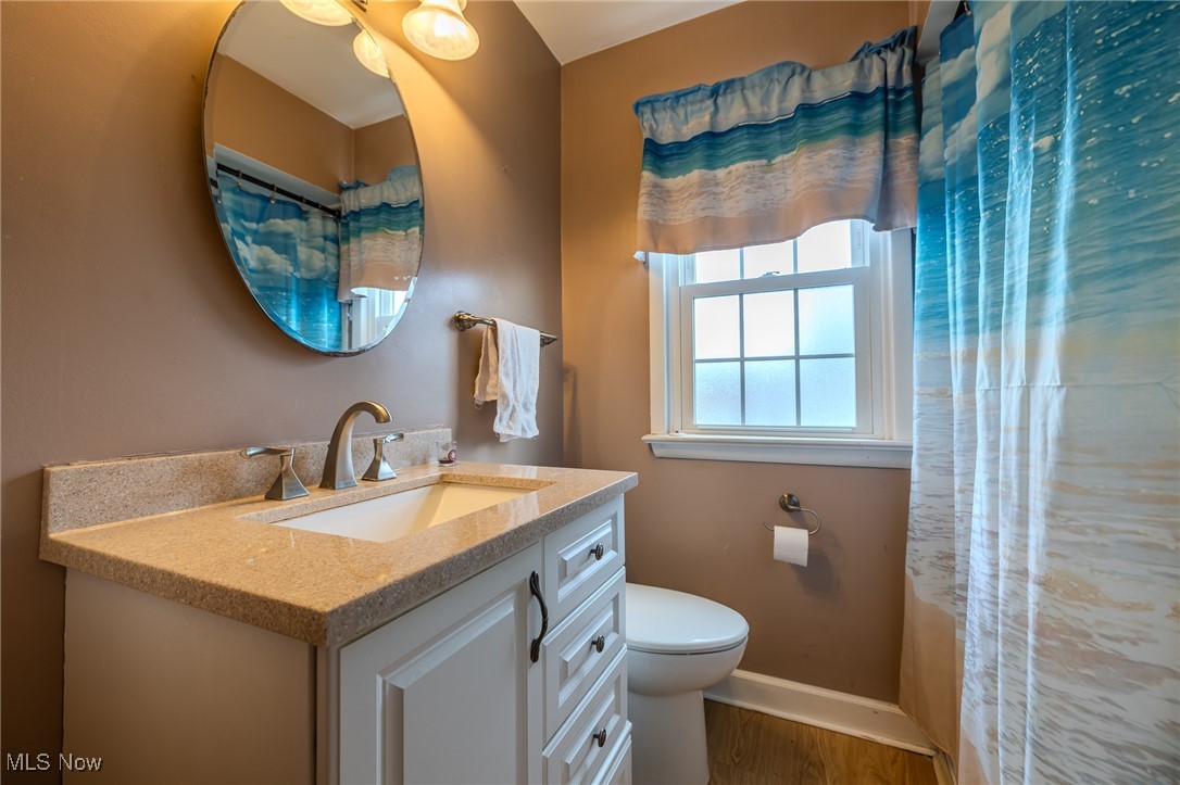 765 Pendley Road Willowick, OH 44095 - Photo 47 of 50 Bathroom with hardwood / wood-style flooring, vanity, curtained shower, and toilet