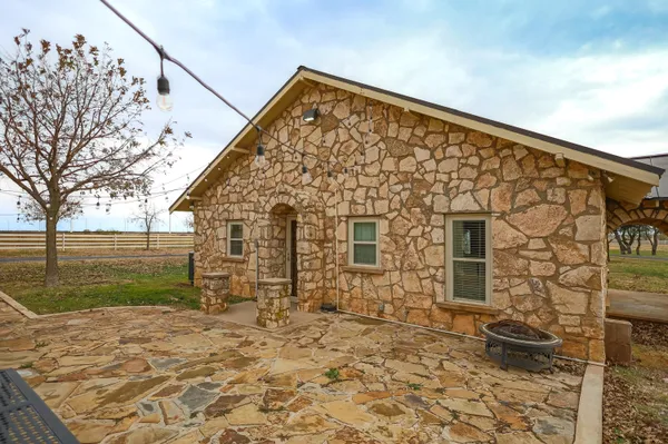 a kitchen with stainless steel appliances kitchen island granite countertop a table chairs and a refrigerator