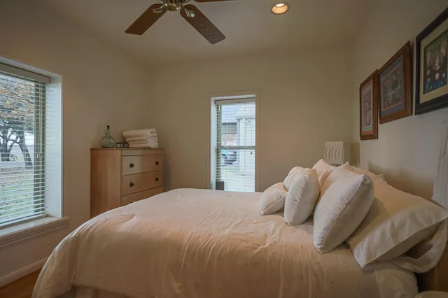a bedroom with furniture and a flat screen tv
